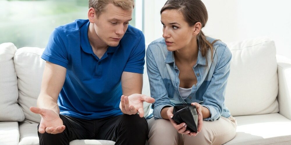 Horizontal view of couple having empty wallet